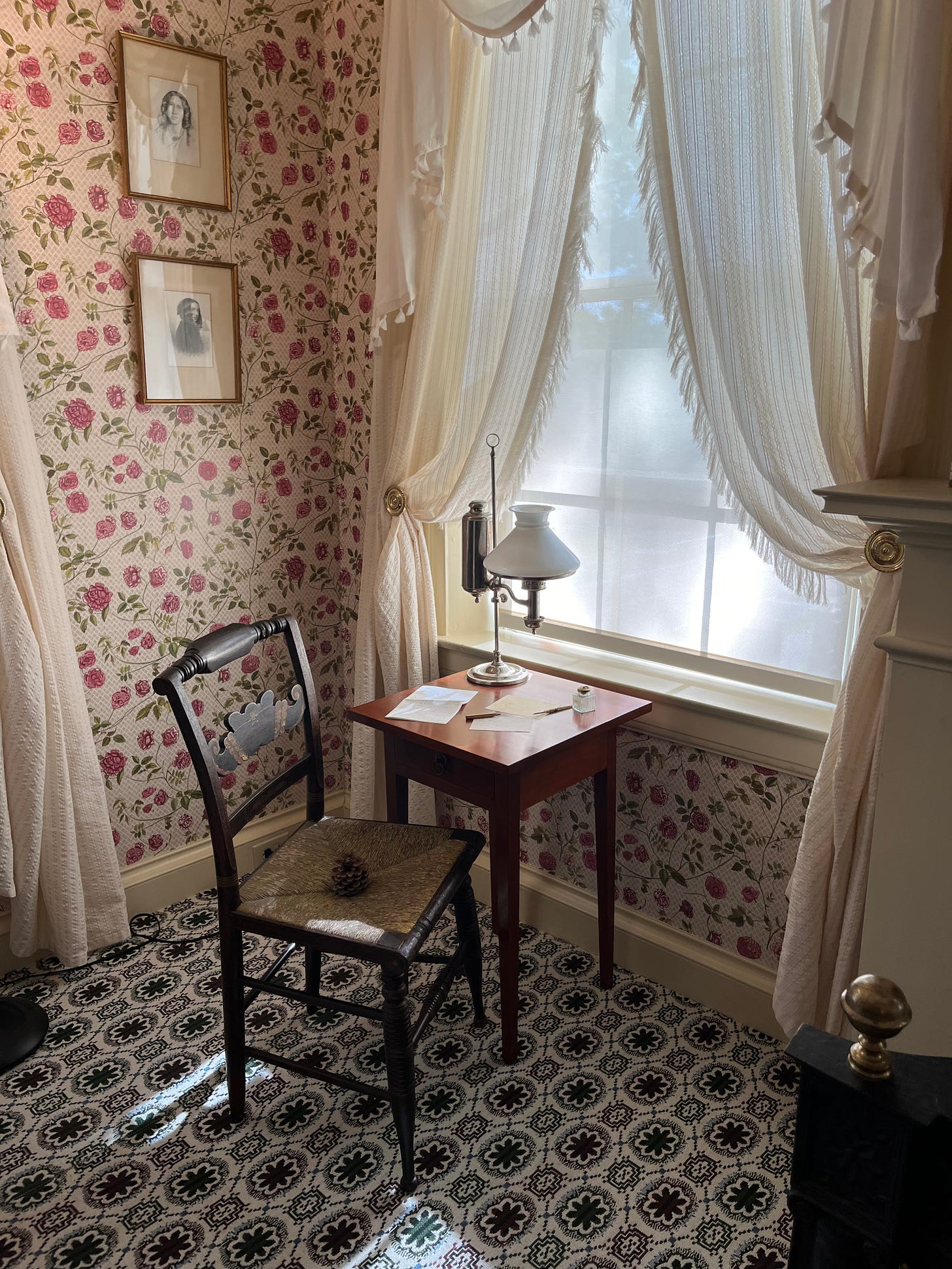 A photo of Emily Dickinson's desk with a pinecone in the desk chair.