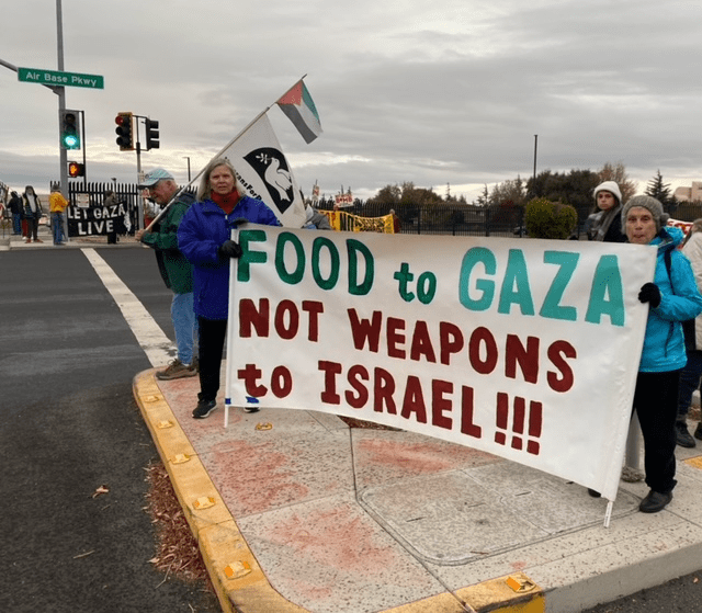 A group of people holding signs

Description automatically generated