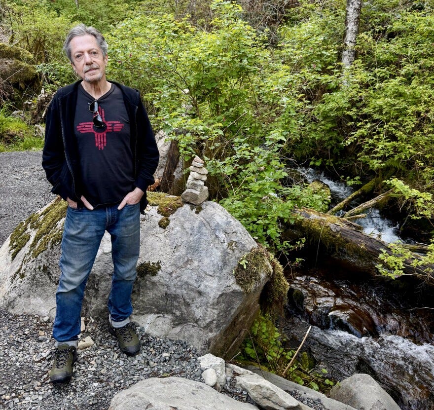 Art Donnelly, co-chair of the Mapleton Water District, stands at the community's only water source. Federal funding setbacks have kept the unincorporated community from repairing its failing water facility.