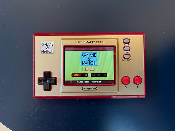 Two top-down shots of the Game & Watch: one with the starting screen of Super Mario Bros. and the second with the game Ball.