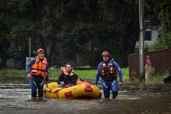 SES teams rescue Simone Baluch, her dog and a litter of kittens from a property in Chipping Norton on Thursday. SES teams rescue Simone Baluch, her dog and a litter of kittens from a property in Chipping Norton on Thursday.