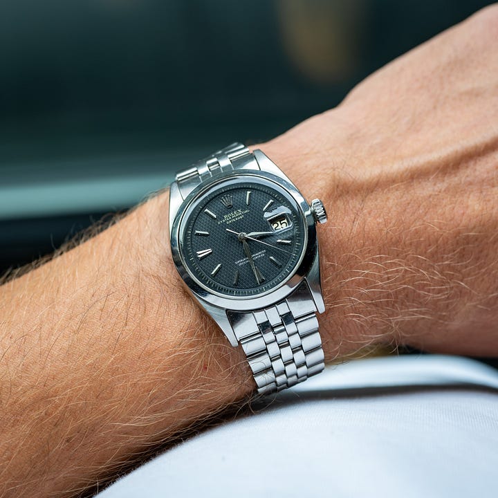 Universal Geneve Polerouter on a zig-zag bracelet and an early Rolex Datejust with no-lume honeycomb dial