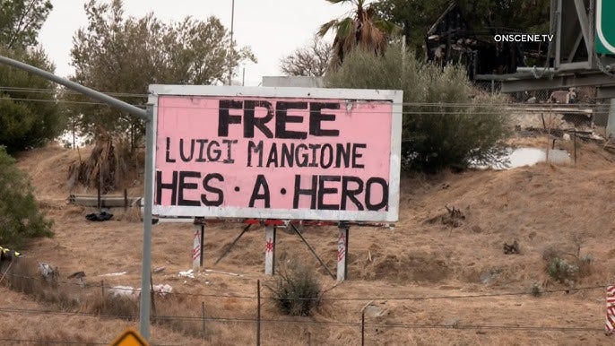 Billboard that reads "Free Luigi Mangione. He's a hero."