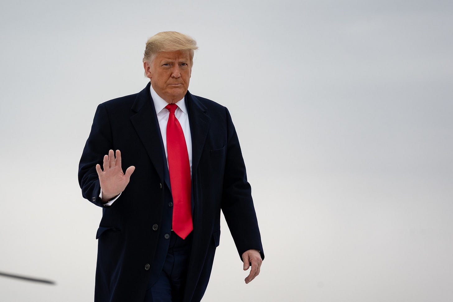 Donald Trump looks at the camera and waves. Donald Trump looks at the camera and waves.