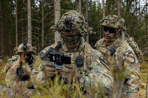 U.S. Army soldiers training with Titan V3 counter-unmanned aerial system technology in a wooded Latvian environment during the multinational Saber Strike 26 exercise.