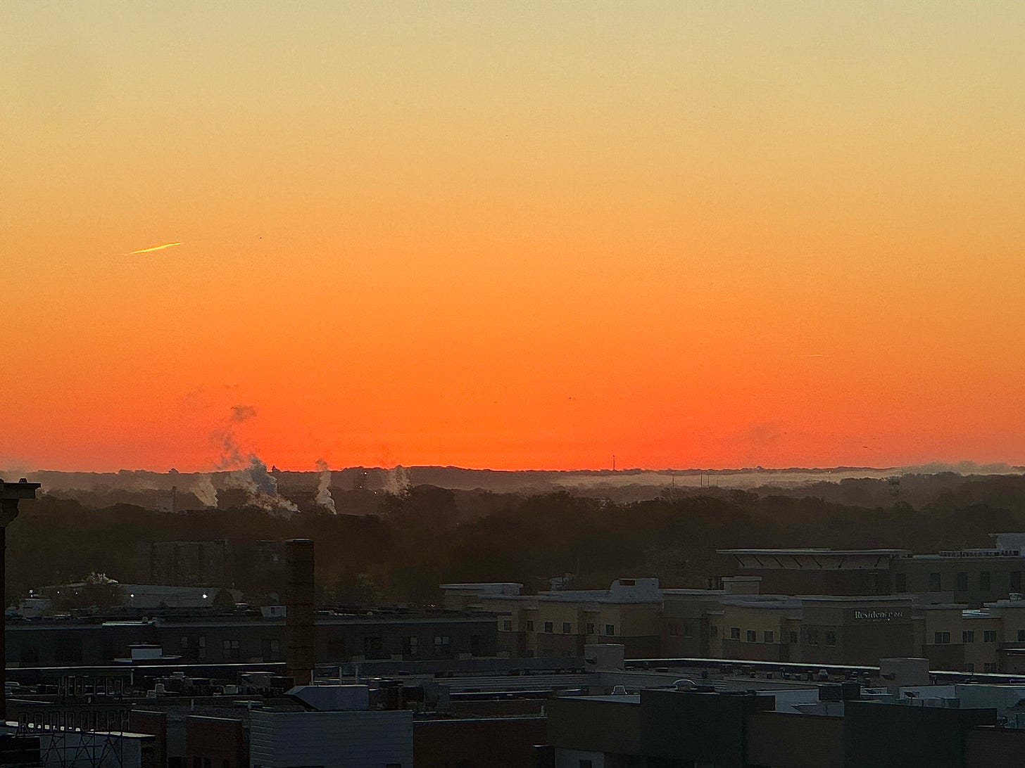Sunrise with contrails and smokestacks Sunrise with contrails and smokestacks