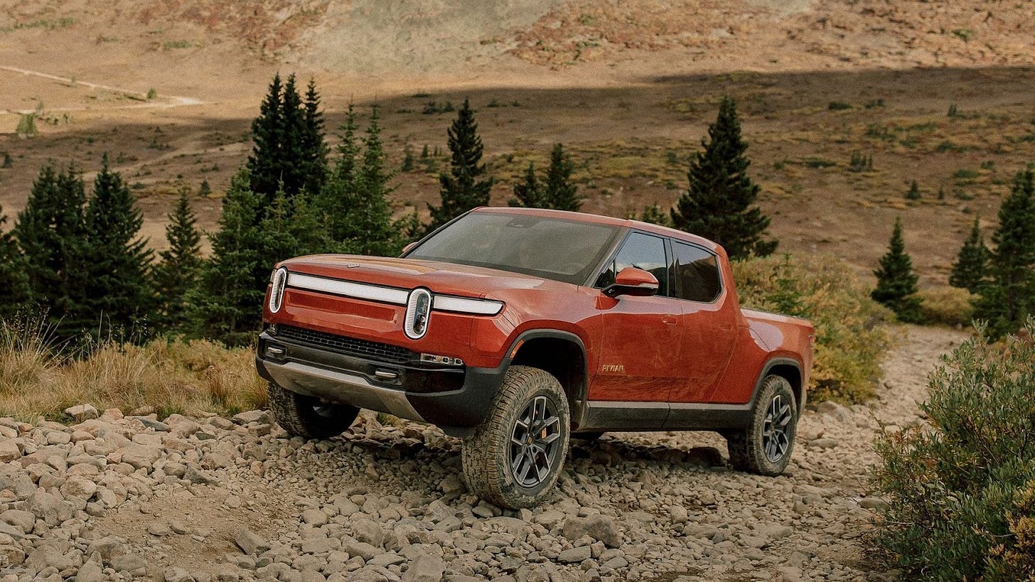 Red Rivian R1T off-roading.