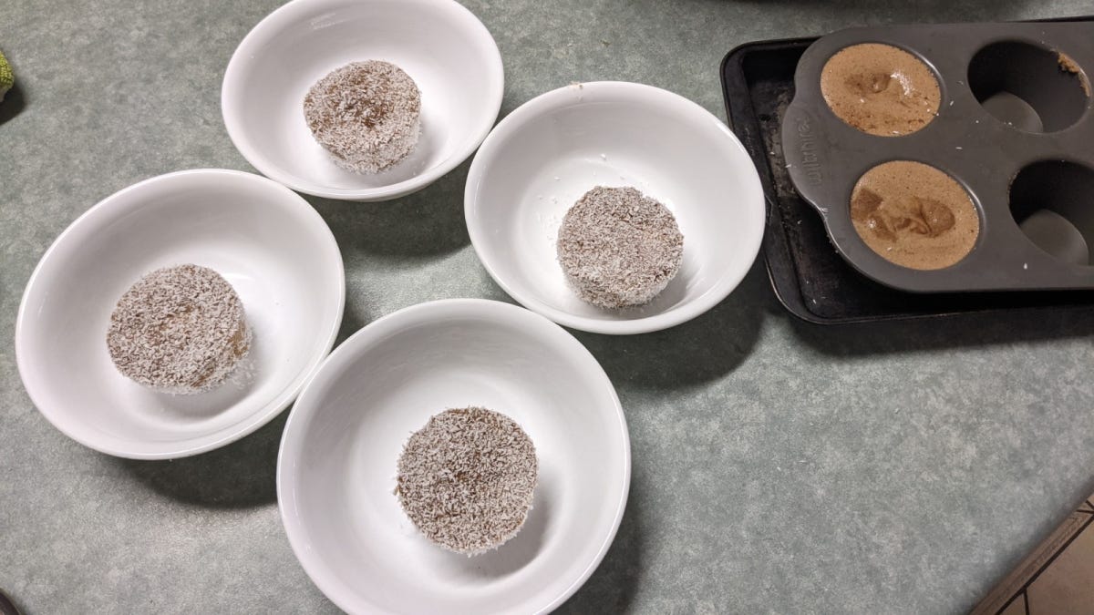 Some short brown cylinders rolled in coconut