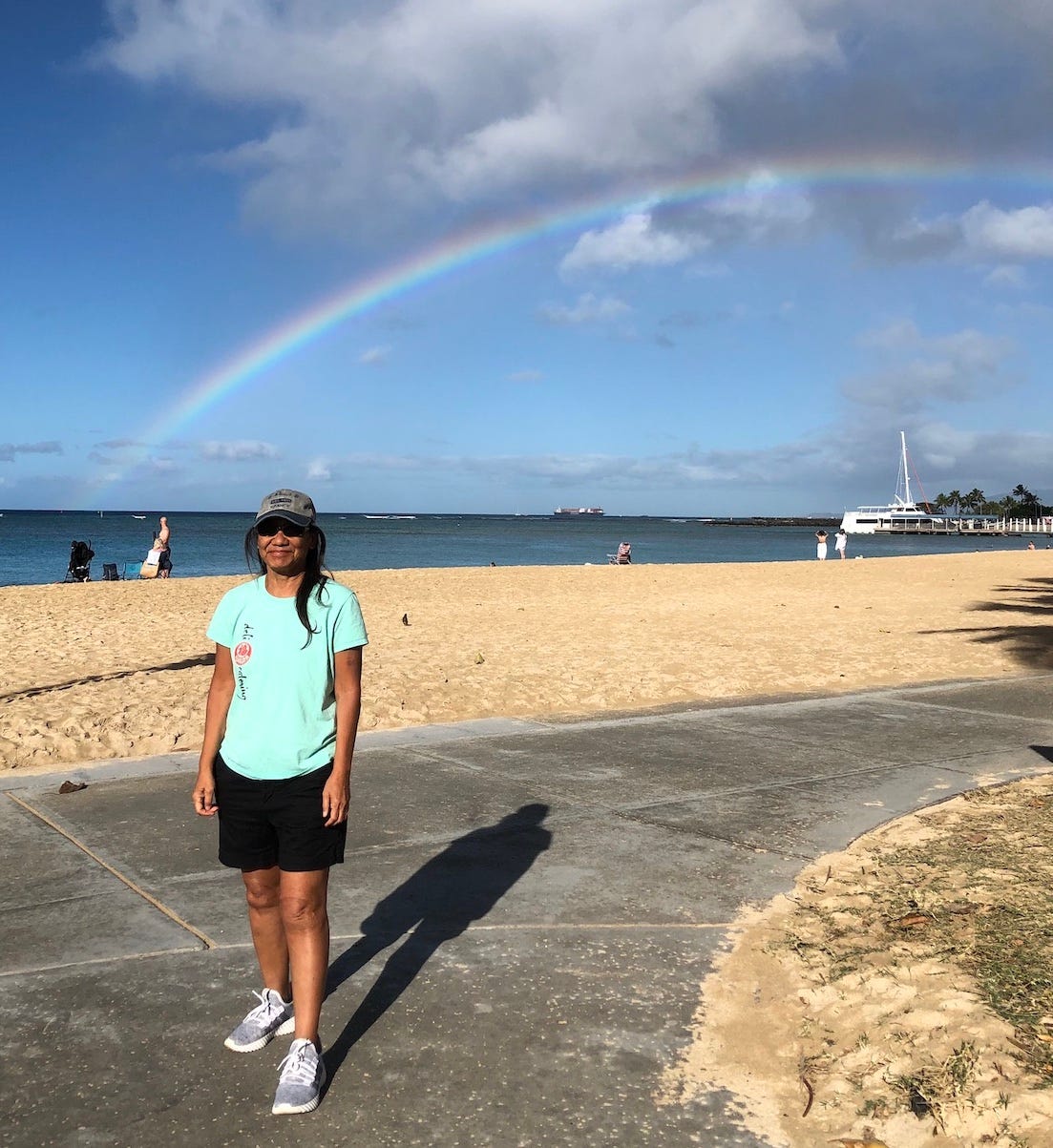 Angeline at Fort DeRussy Beach with a rainbow.