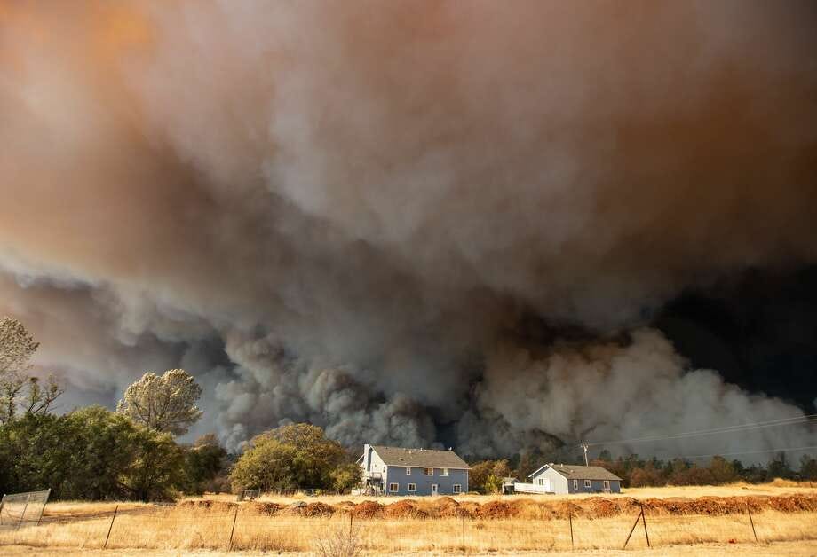 A home overshadowed by towering smoke plumes as the Camp fire races through town in Paradise, CA. JOSH EDELSON/AFP/Getty Images
