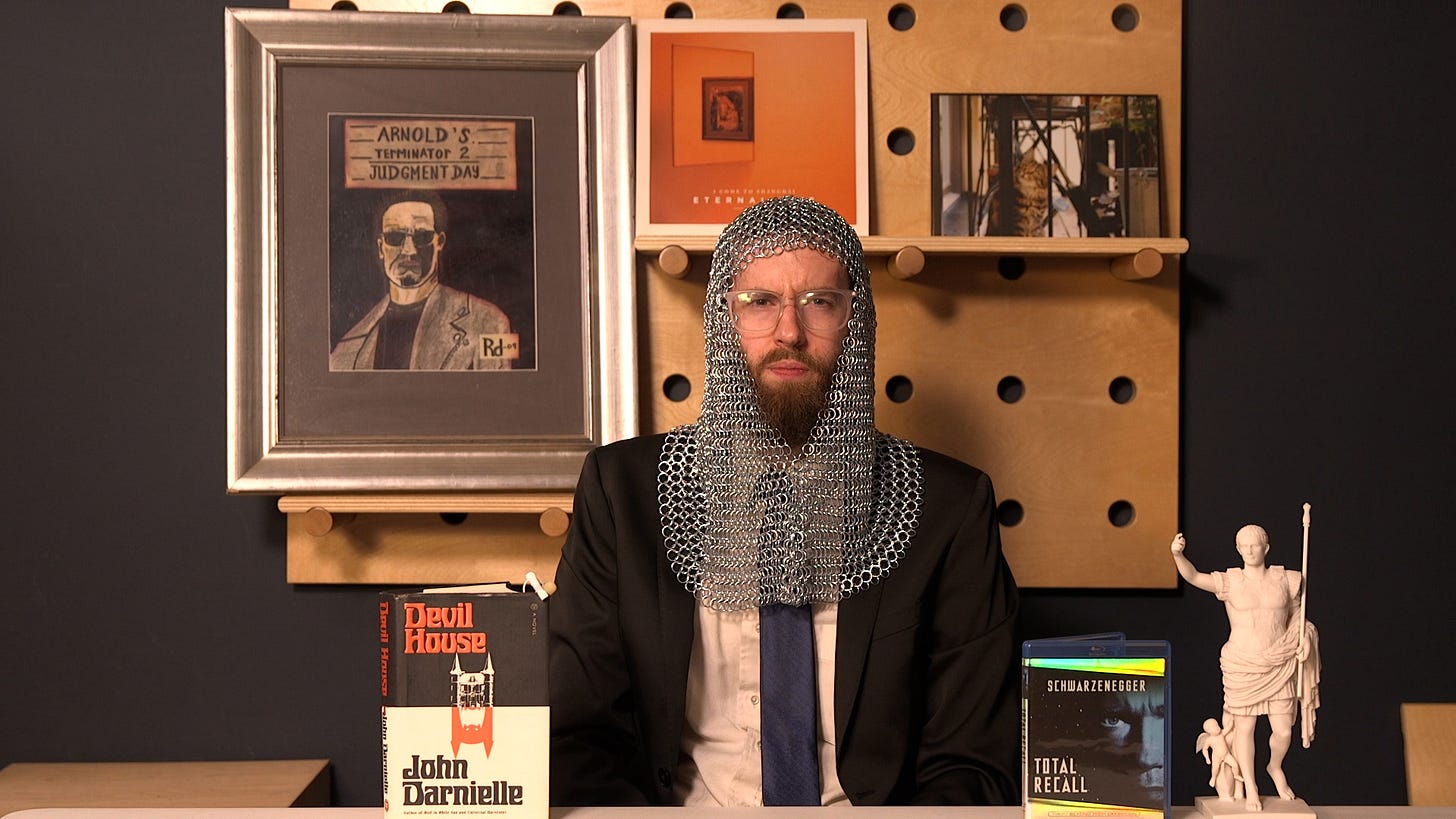 Clayton Ashley, wearing a suit and chainmail armor