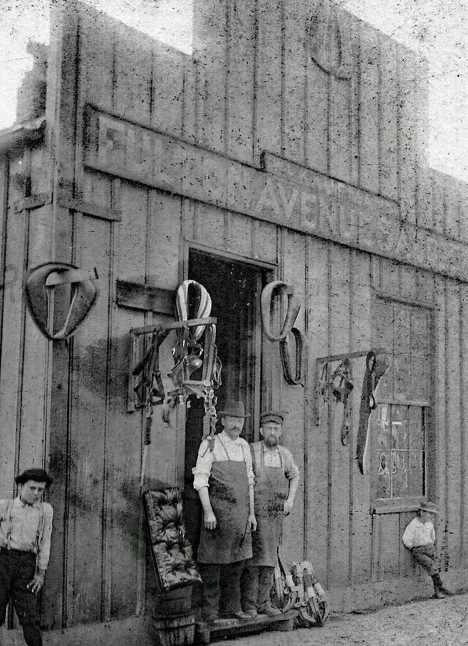 Exterior of H. Heines Harness Shop, 516 Fulton Avenue, Evansville, early 1900s. Henry Heines stands in the doorway, surrounded by the tools and leatherwork of his trade. (Photo from Lynda Heines family collection)
