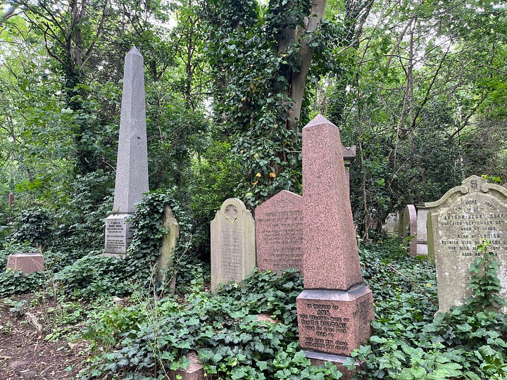 Obelisk grave monuments in an overgrown cemetery
