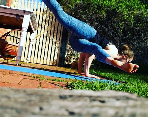 Image 1: Laura in side crow pose with split legs on a blue yoga matt outside on red pavers. Image 2: Black and white image of Laura outside on pavers in child's pose, a brick wall and sliding door in background. Image 3: Laura wearing colourful yoga pants in half lift, outside with a while mug at the top of her blue mat. Image 4: Laura in bambook pose in low light before sunrise in side, a wooden chair and rocking chair in the background. Image 5: Laura sitting on her blue yoga mat patting her white bun Percy on floating floors. Image 6: Laura in red pj pants with legs up the wall.