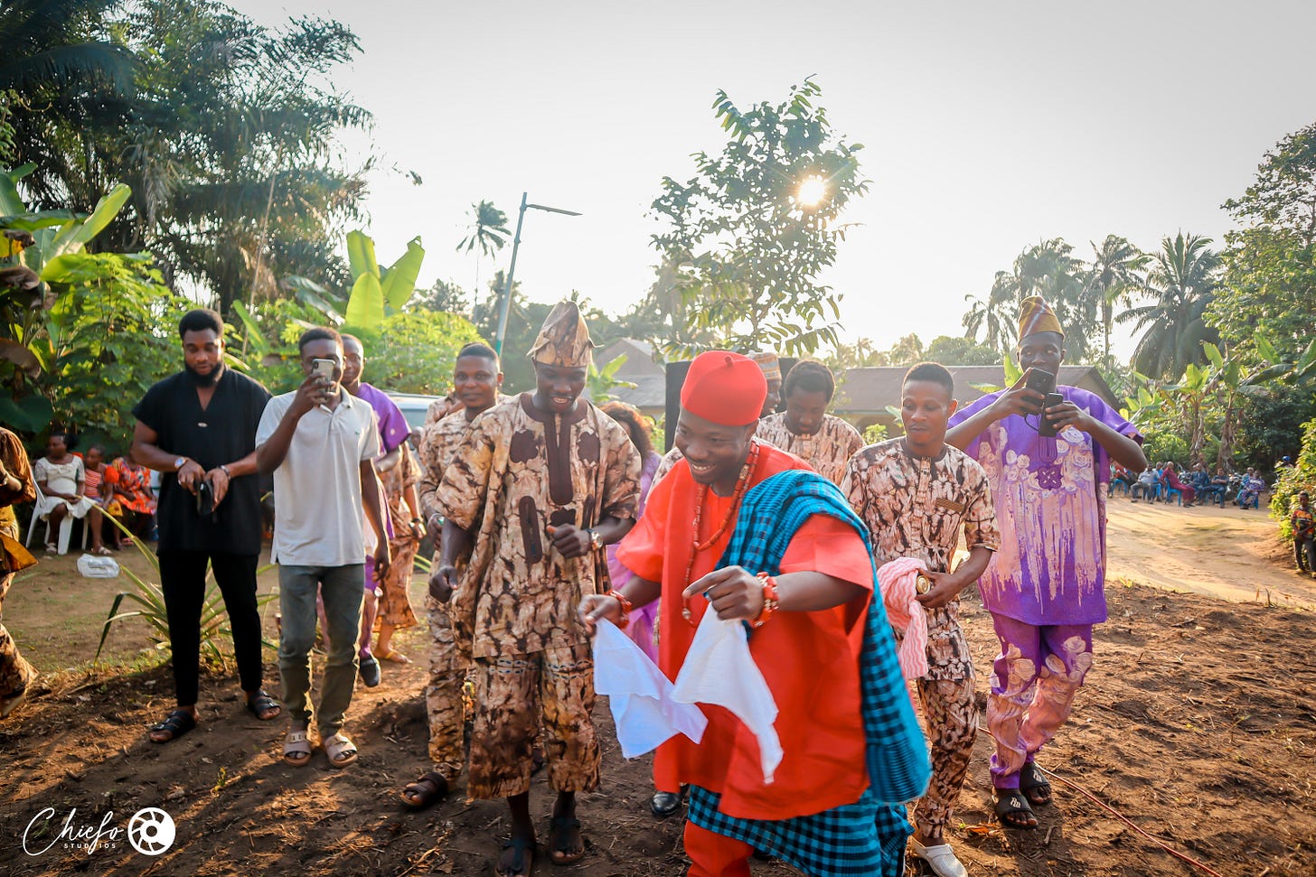 A group of Yoruba groomsmen dancing 