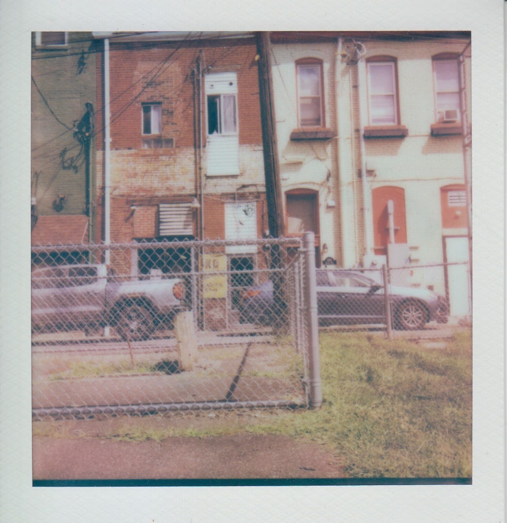 Polaroid of the back of Armstrong Playground showing row houses that are over 120 years old.