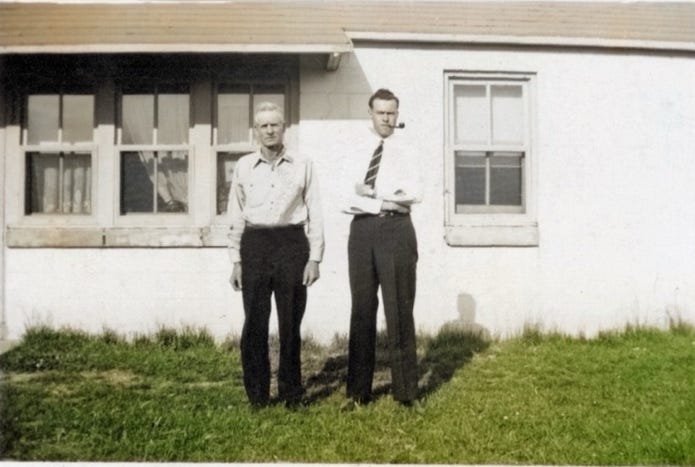 Men standing in front of a house

Description automatically generated