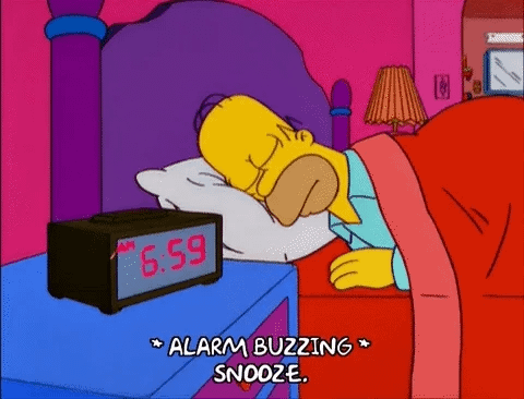 Homer Simpson turning off his alarm clock while asleep