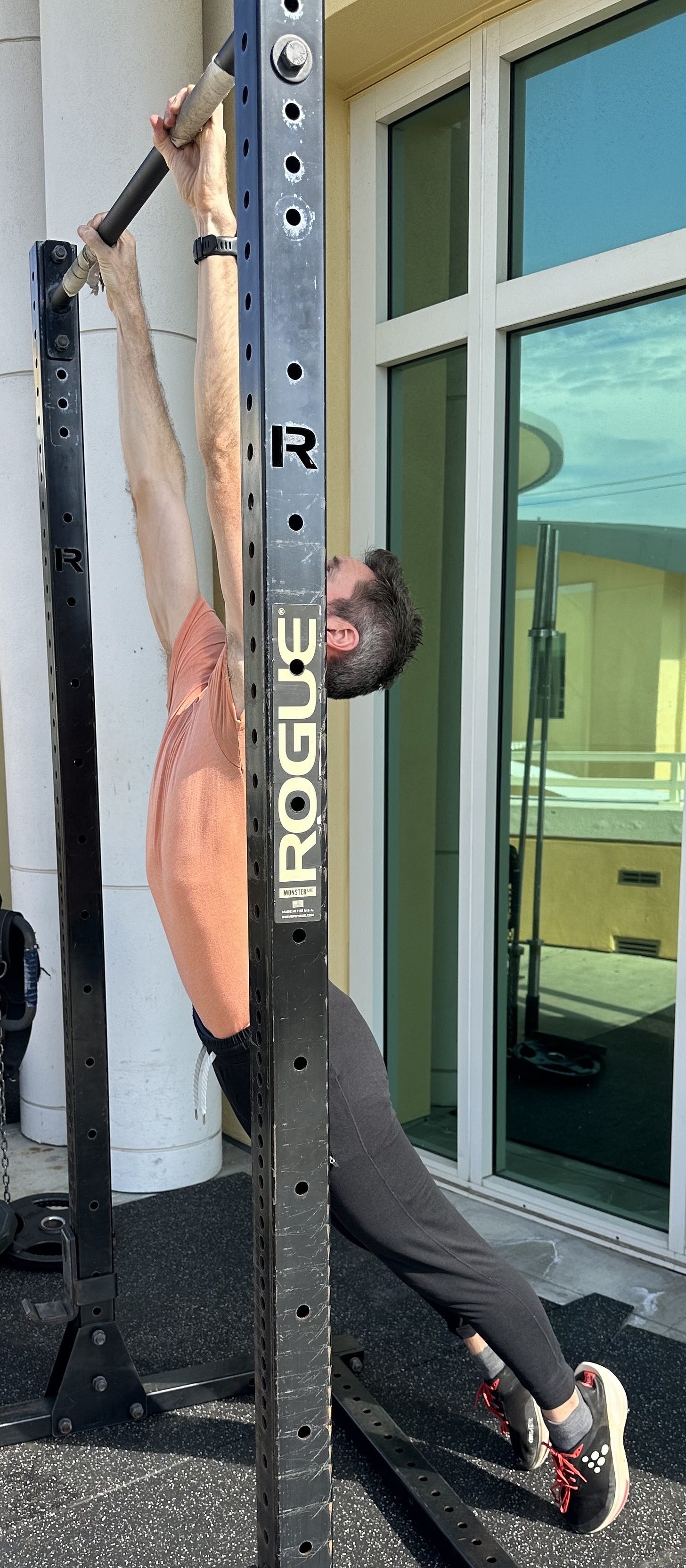 a man hanging from a bar