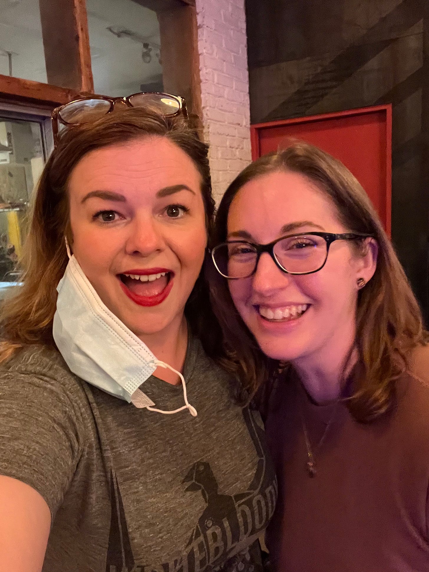 Amber takes a selfie with Allison. Both smile broadly into the camera.