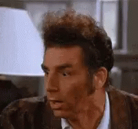 a close up of a man 's face with a surprised expression .