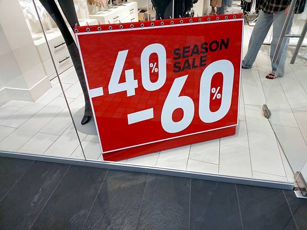 Season Sale at Mall Offers Discounts Ranging From Forty to Sixty Percent on Select Items Shoppers explore a vibrant mall during a seasonal sale featuring attractive discounts of forty to sixty percent on various products displayed in store windows. retail markdowns stock pictures, royalty-free photos & images
