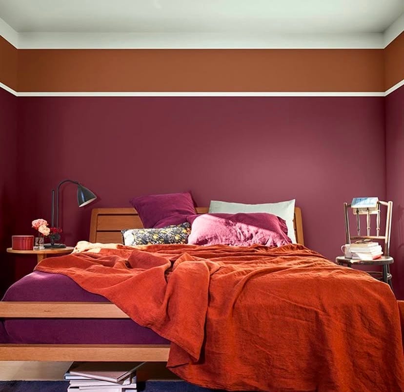 rich burgandy painted bedroom with ochre painted stripe below the ceiling rich burgandy painted bedroom with ochre painted stripe below the ceiling