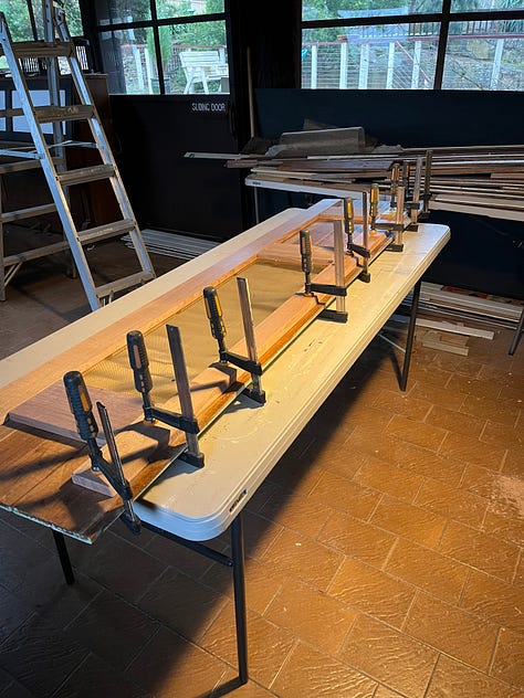 a set of photos showing the rebating, glueing, sanding and painting of a set of wooden doors.