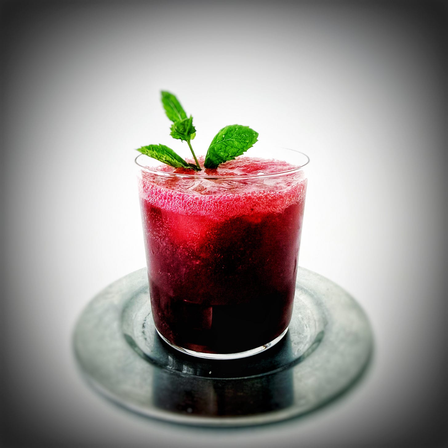 A finished cherry smash with dainty mint garnish. A finished cherry smash with dainty mint garnish.