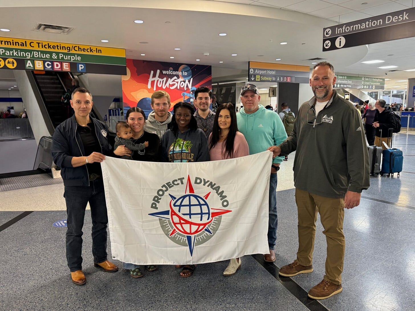 A group of people holding a banner

AI-generated content may be incorrect.