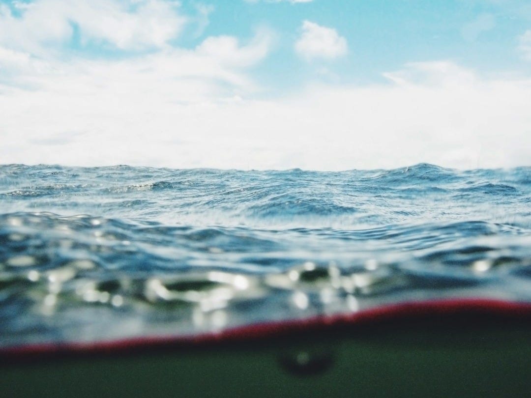 body of water under cloudy sky