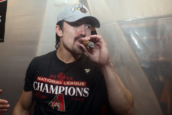 Diamondbacks rookie Corbin Carroll smokes a cigar after leading the worst NL playoff team to the World Series. Depending on your view of the current MLB playoff format, this is either the best or worst thing that has happened in the history of the sport. (Photo by Tim Nwachukwu/Getty Images)