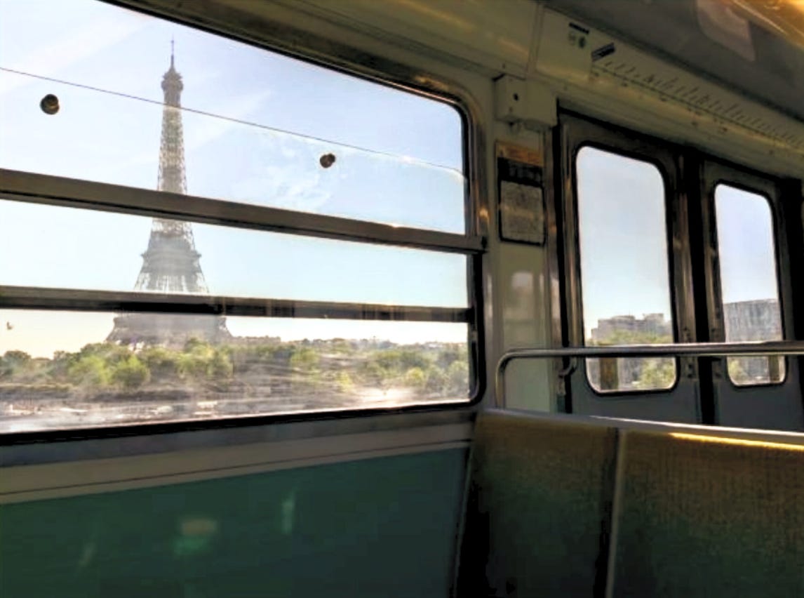 View of the Eiffel Tower from inside a Paris metro train, reflecting the emotional experience of adjusting to life abroad.