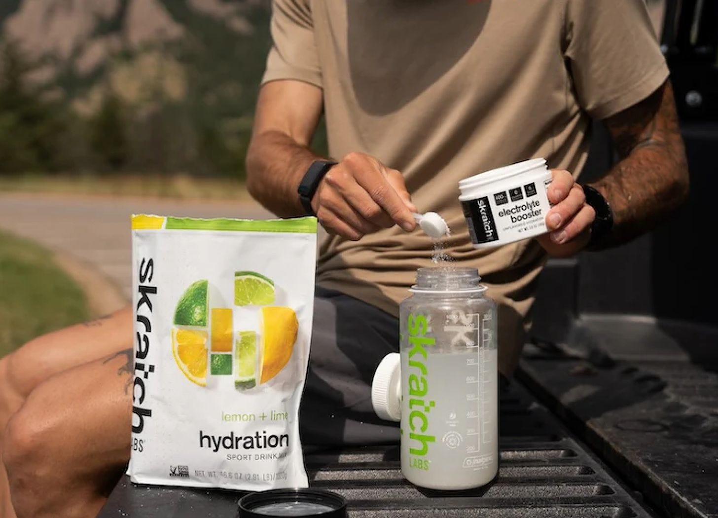 A person preparing a Skratch Labs electrolyte drink by mixing a hydration powder with water before a workout. A person preparing a Skratch Labs electrolyte drink by mixing a hydration powder with water before a workout.