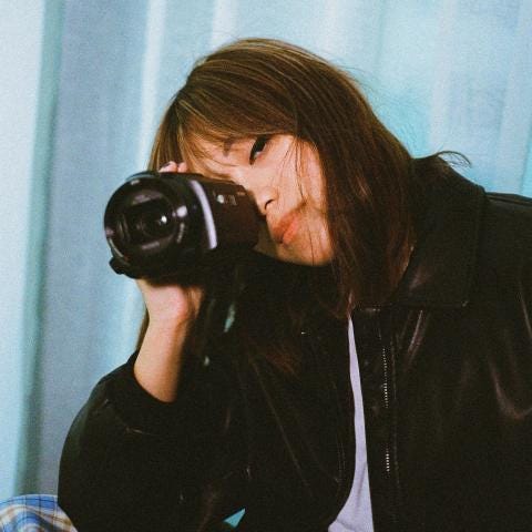 young woman holding camcorder