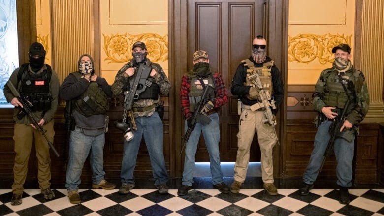Armed people in Michigan&#39;s legislature protest proposed coronavirus  restrictions extension | CBC News