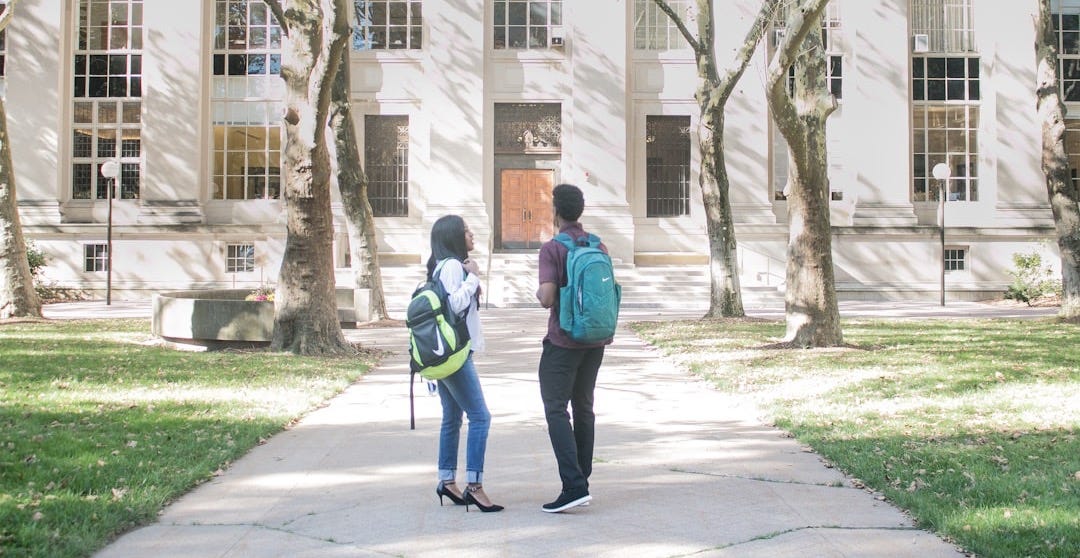 a couple of people that are standing in front of a building