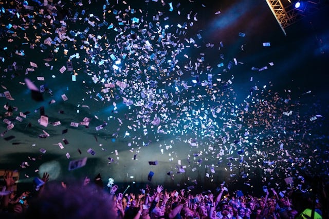 Huge crowd of people at night, being showered by confetti. Huge crowd of people at night, being showered by confetti.