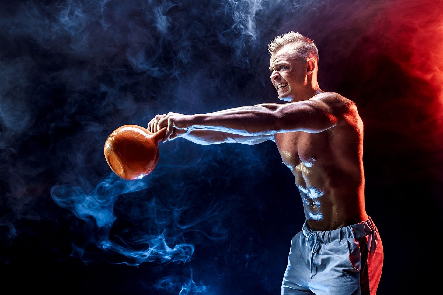 athletic, fit young man swinging a kettlebell, Time2Thrive.ca athletic, fit young man swinging a kettlebell, Time2Thrive.ca