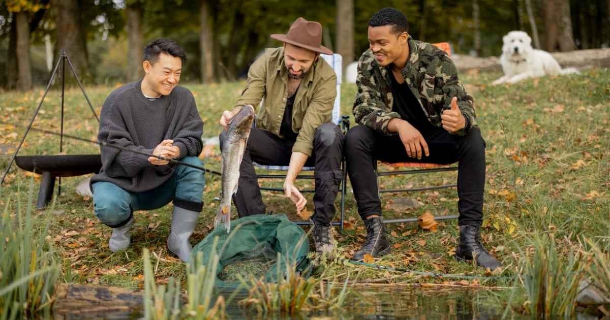 male friends looking at fish they have just caught