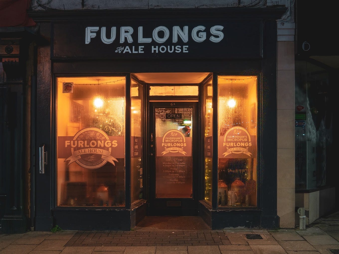 Furlongs after dark, its old shop windows steamed up with condensation and warm light shining through