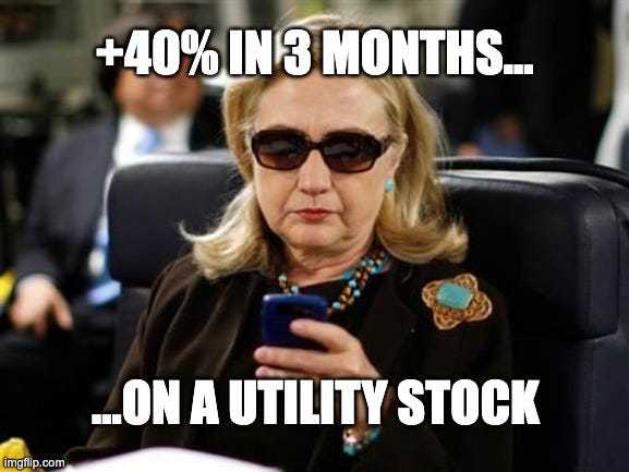 A meme featuring Hillary Clinton wearing sunglasses and looking at a smartphone while seated on a plane. The image includes white, bold impact-style text that reads: "+40% IN 3 MONTHS... ON A UTILITY STOCK." The meme humorously conveys a sense of cool confidence and unexpected success regarding a high-performing investment in a typically stable sector.