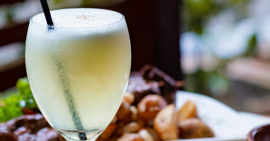 clear wine glass with yellow liquid clear wine glass with yellow liquid