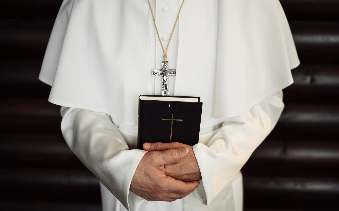 An image of a pope holding a Bible.