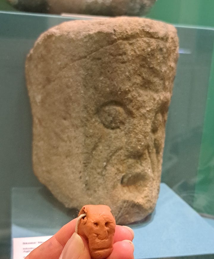 Two faces of the Corleck head on the top row with an image of a stamp featuring the Corleck head between them. Two images of other stone heads on display in our museum. All of them are made of a greyish-brown grainy stone, their facial features minimally represented and expressionless.