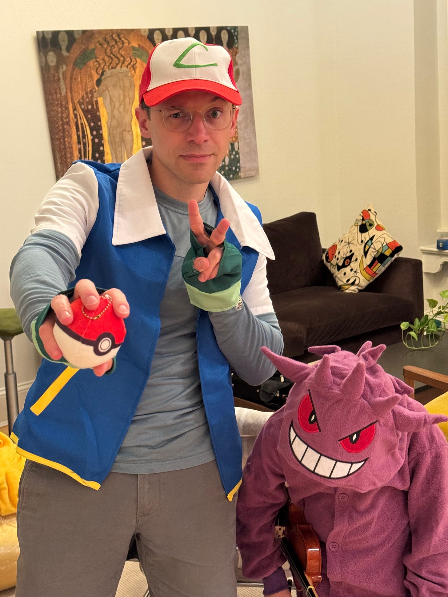 David Epstein and his son in Pokémon costumes, smiling for a Halloween photo.