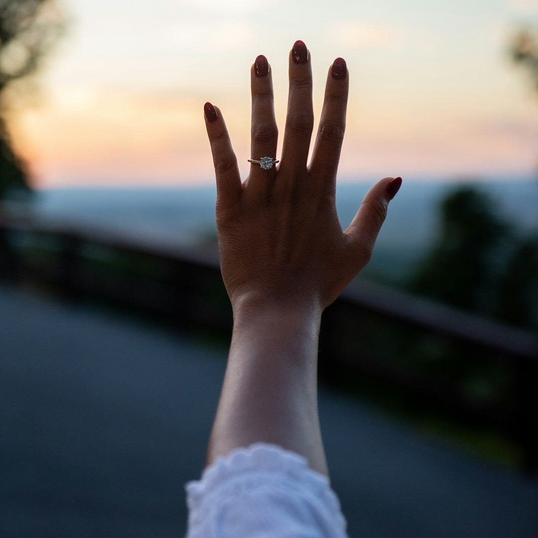 a woman's hand with a ring on it
