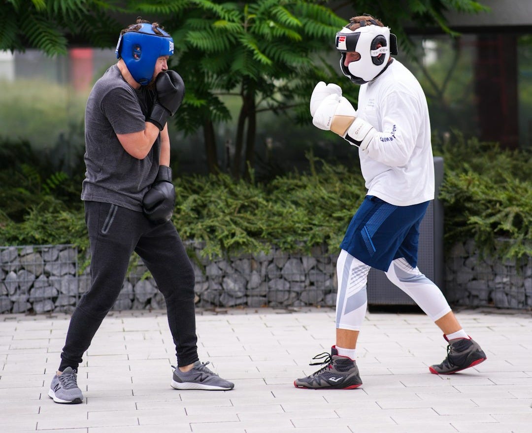 A man wearing a mask and boxing gloves