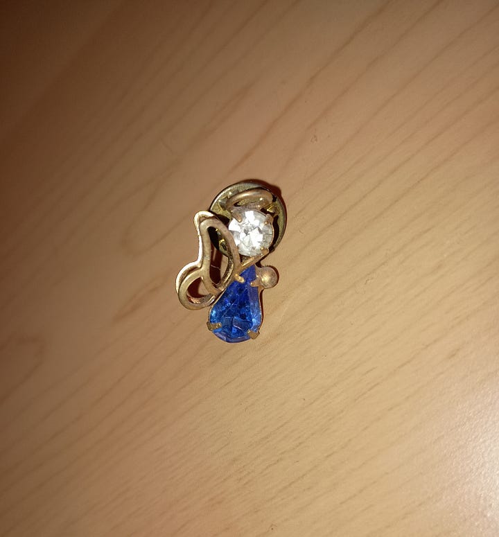 a blue and gold angel and a crystal unicorn with a gold bow