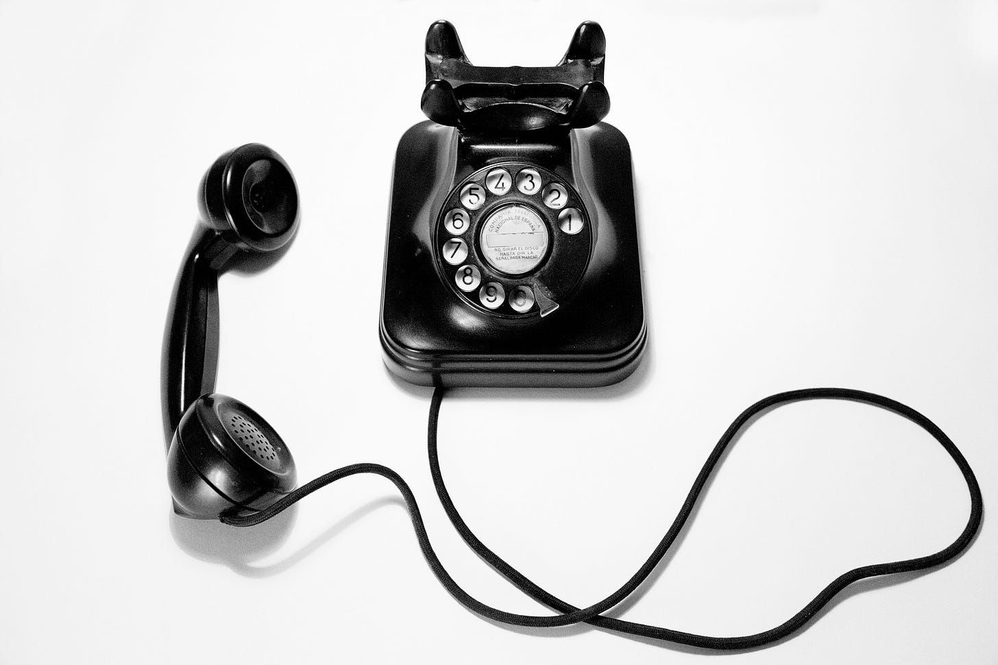 Vintage rotary phone off the hook. A thematic image for 'When I Almost Called Bob,' a story in the 'White Collar, Black Ink' series by Dilia Wood, based on her experience developing the Inspirador venue (now SoHo63 under new ownership) in Chandler, Arizona.